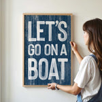 a woman holding a sign that says let&#39;s go on a boat