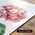 a close-up of a watercolor painting of a pink flower on a white background.