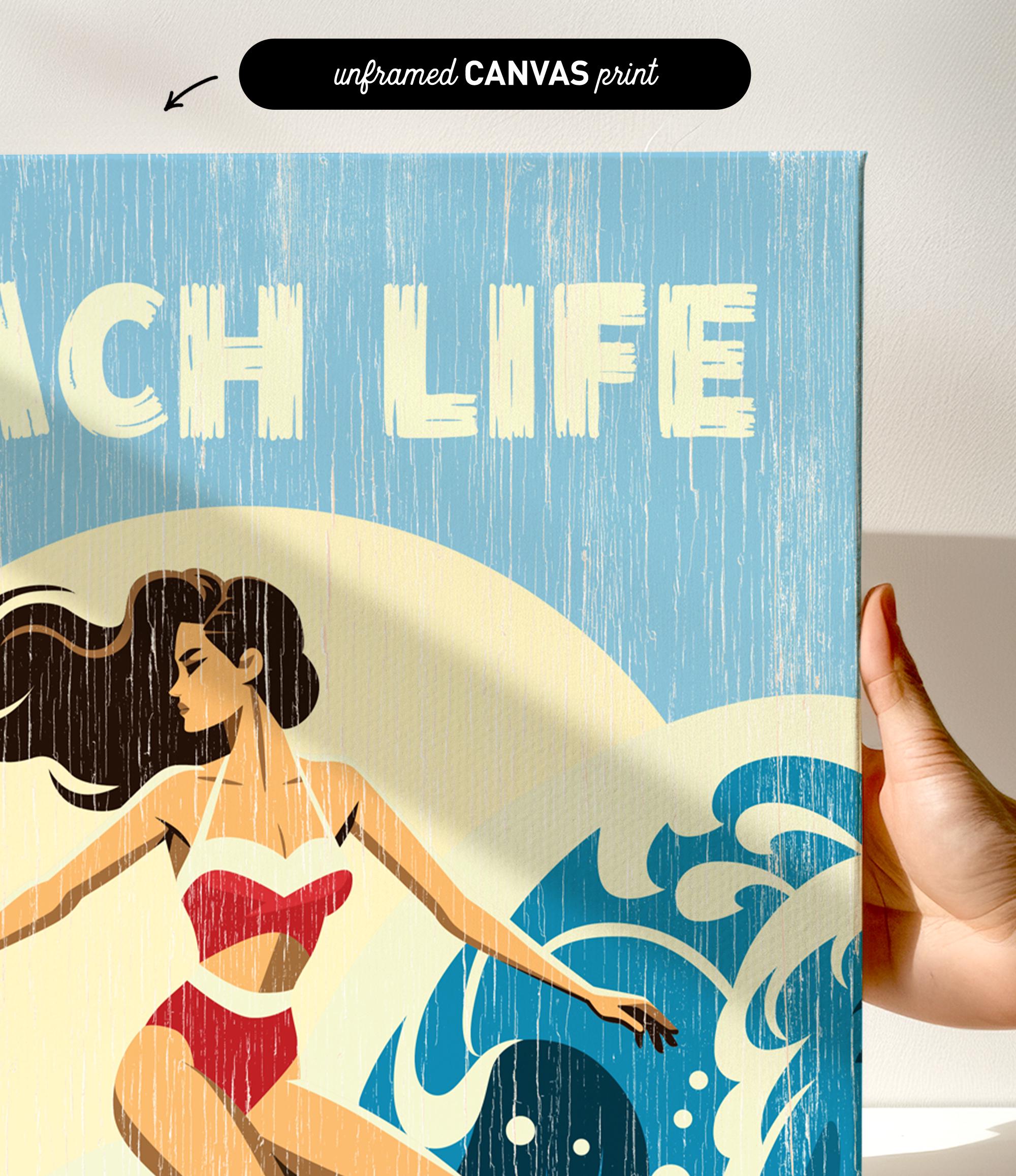 a hand holding a canvas print with a beach scene and a woman in a red swimsuit.