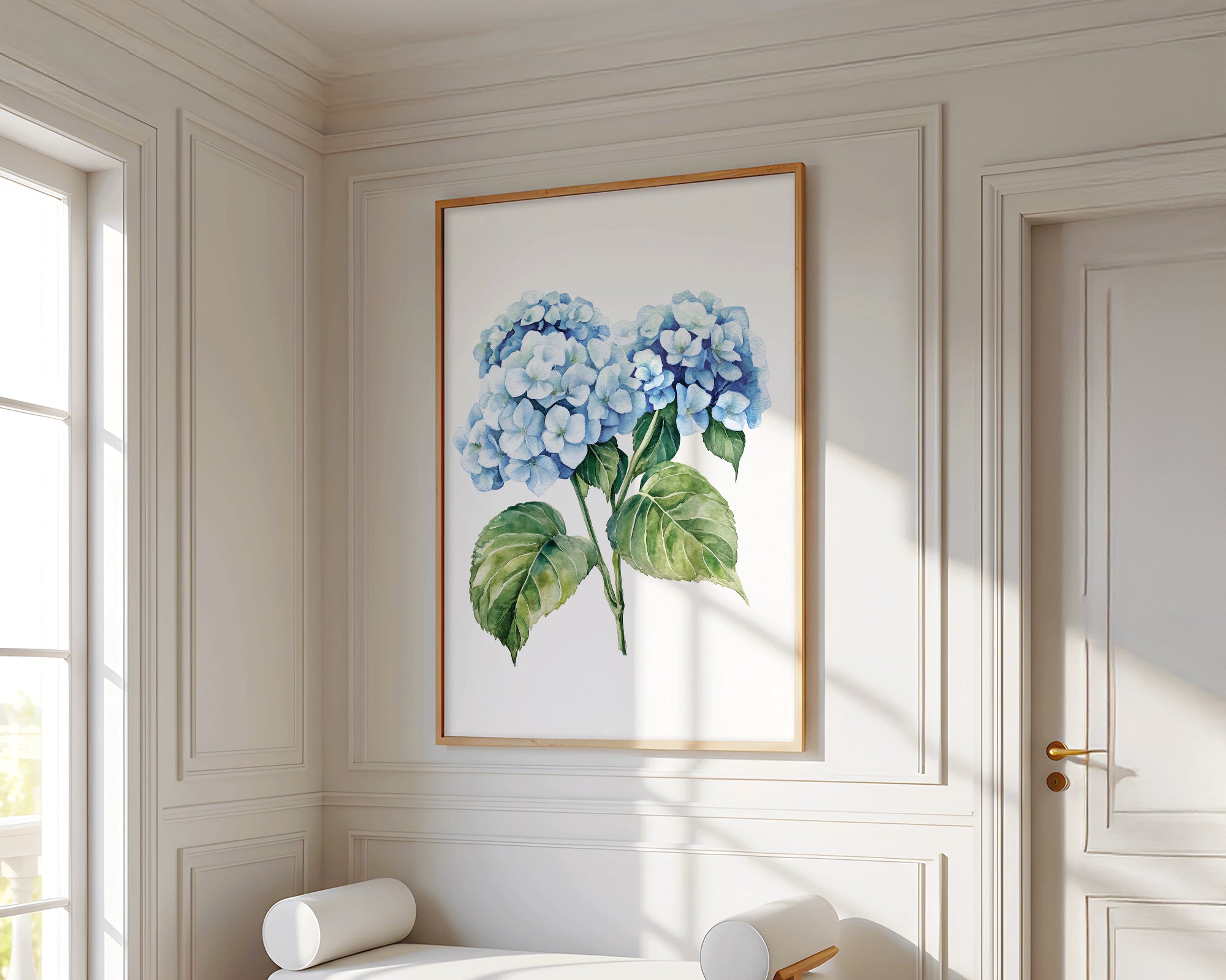 a white room with a large painting of blue hydrangeas hanging on the wall. In front of the painting, there is a white bench with two white cushions. The room has white walls and a wooden floor, creating a clean and elegant atmosphere.