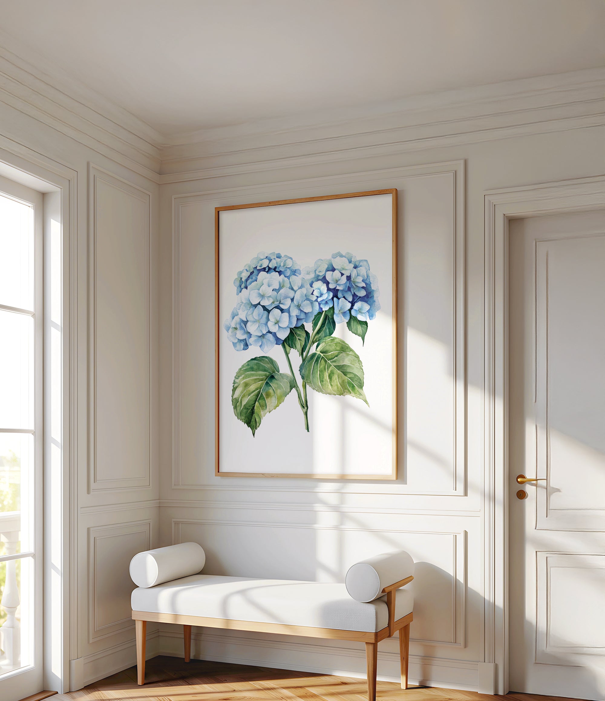 a white room with a large painting of blue hydrangeas hanging on the wall. In front of the painting, there is a white bench with two white cushions. The room has white walls and a wooden floor, creating a clean and elegant atmosphere.