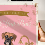 a pink background with a brown dog and a golden faucet, along with the text "Don't forget to wash your paws".