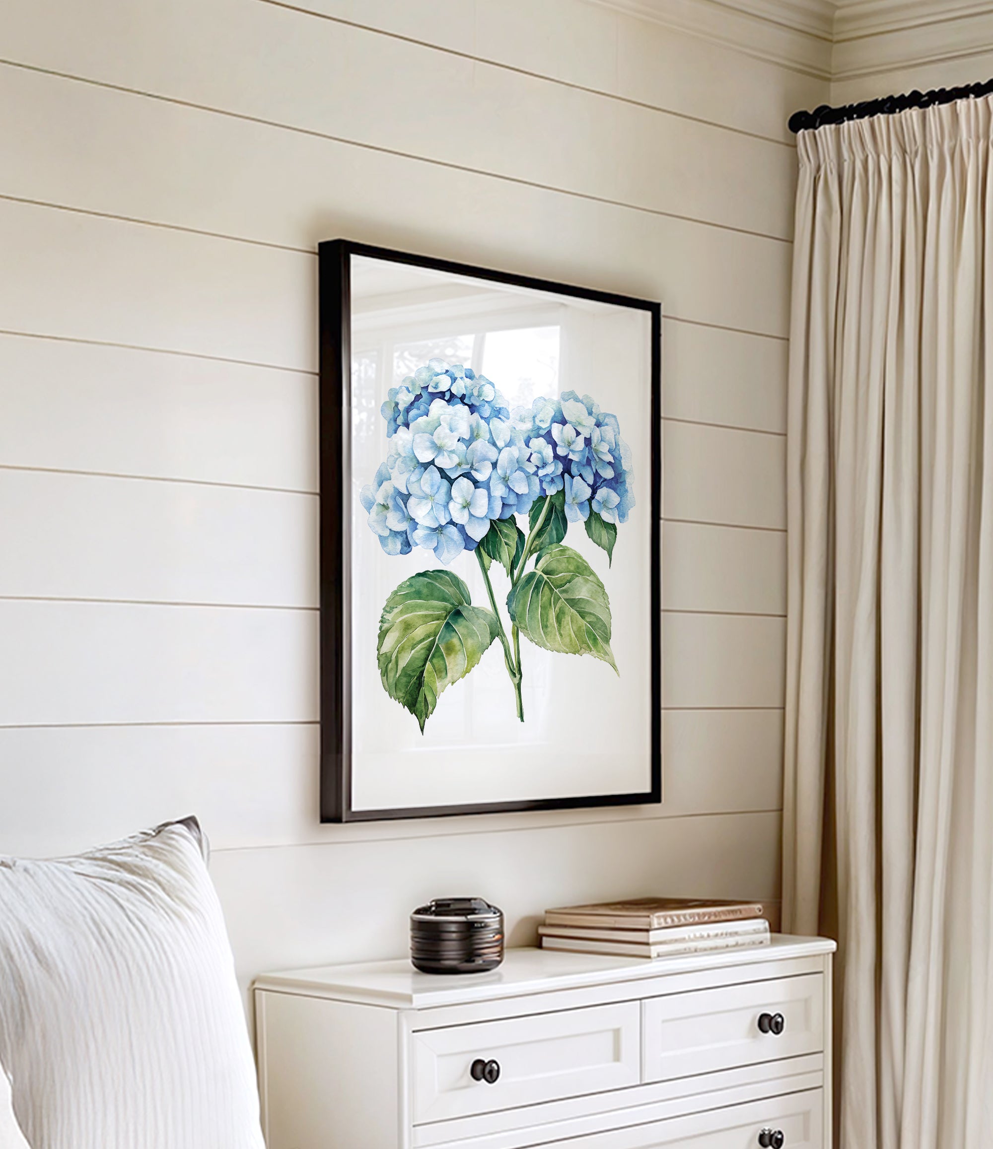 a white dresser with a framed picture of blue hydrangeas hanging on the wall above it.