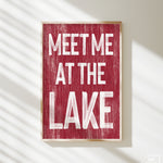 a red sign that says meet me at the lake