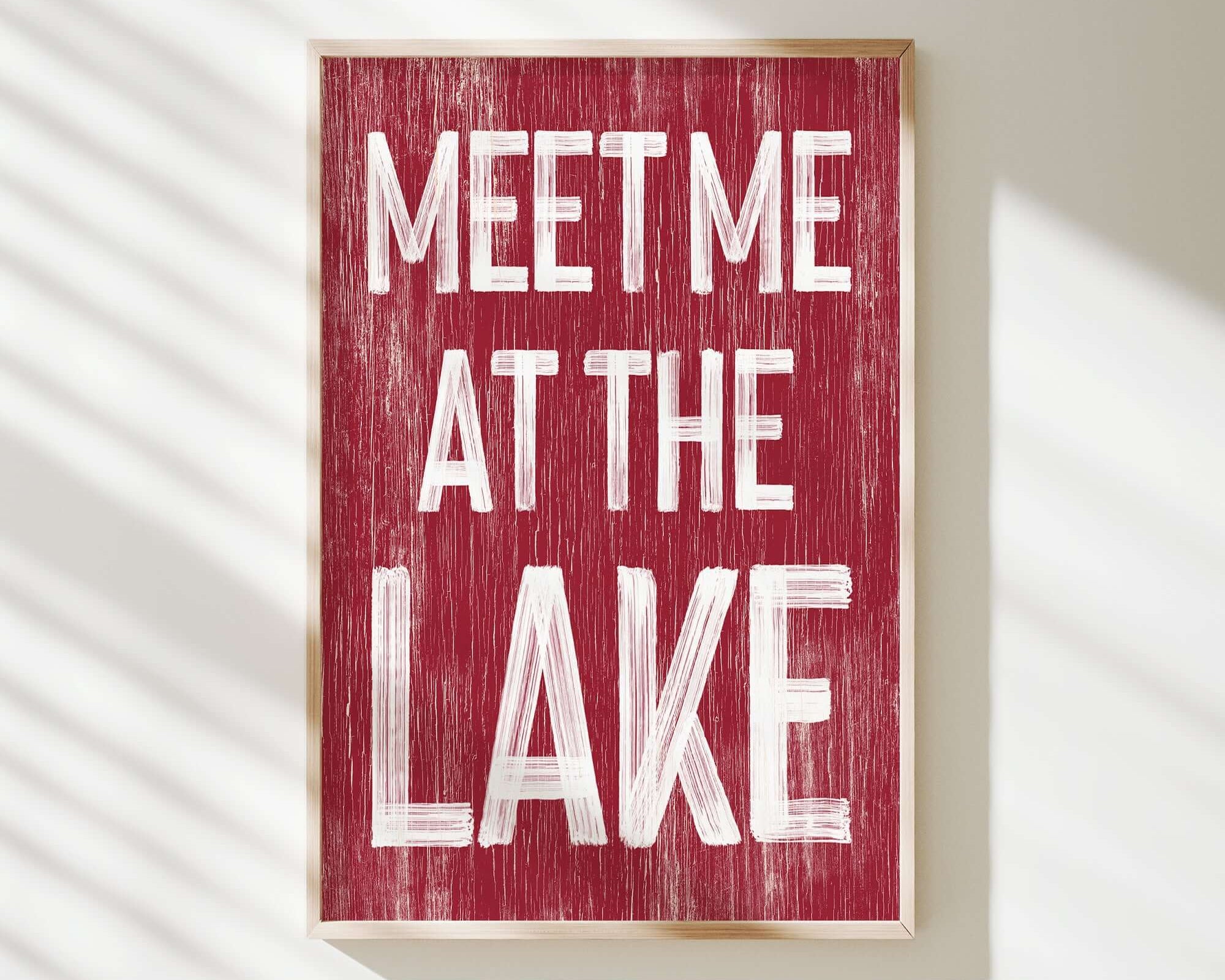 a red sign that says meet me at the lake