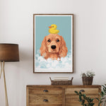 A framed illustration of a golden retriever dog with a yellow rubber duck on its head, set against a blue background with white bubbles.