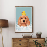 A framed illustration of a golden retriever dog with a yellow rubber duck on its head, set against a blue background with white bubbles.