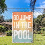 a sign on a fence that says go jump in the pool