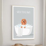 A framed poster with a dog sitting in a bathtub filled with bubbles, accompanied by the text "WASH YOUR PAWS".