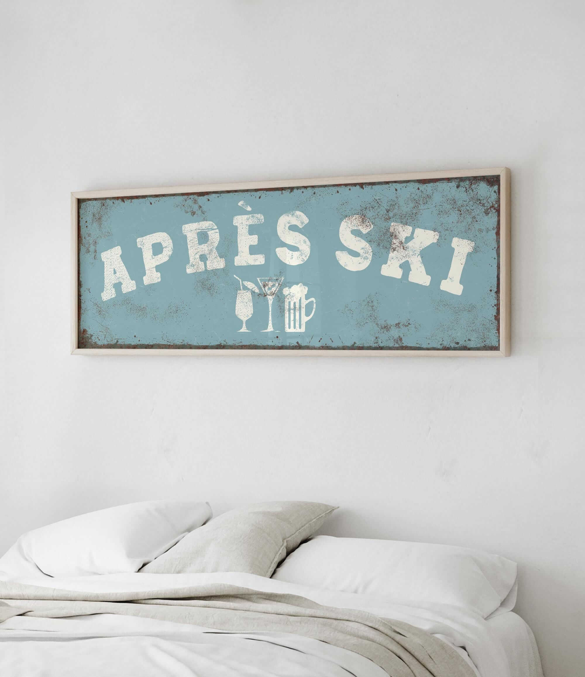 a bedroom with a bed and a framed sign that reads "APRES SKI" above it.