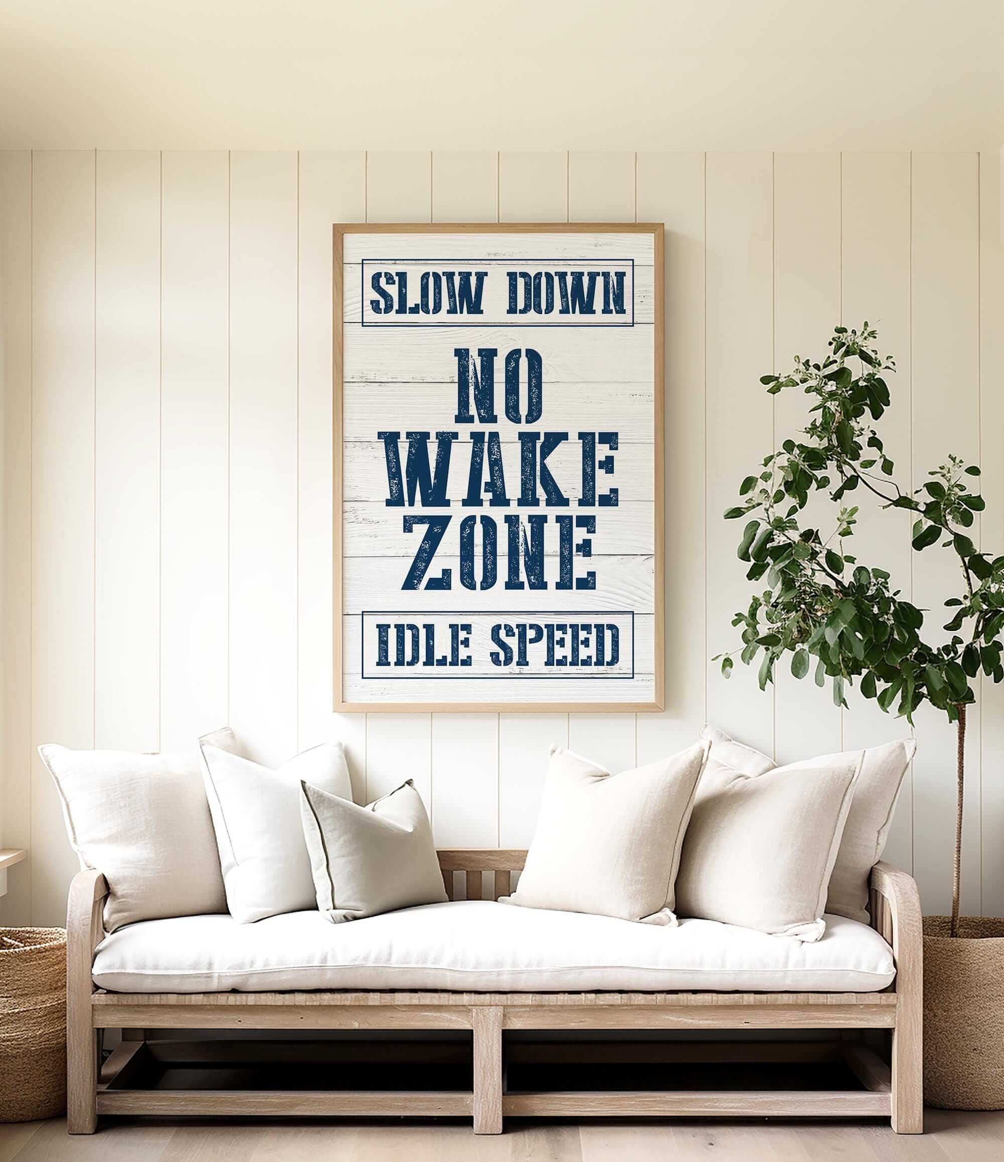 a living room with a white couch and a poster on the wall