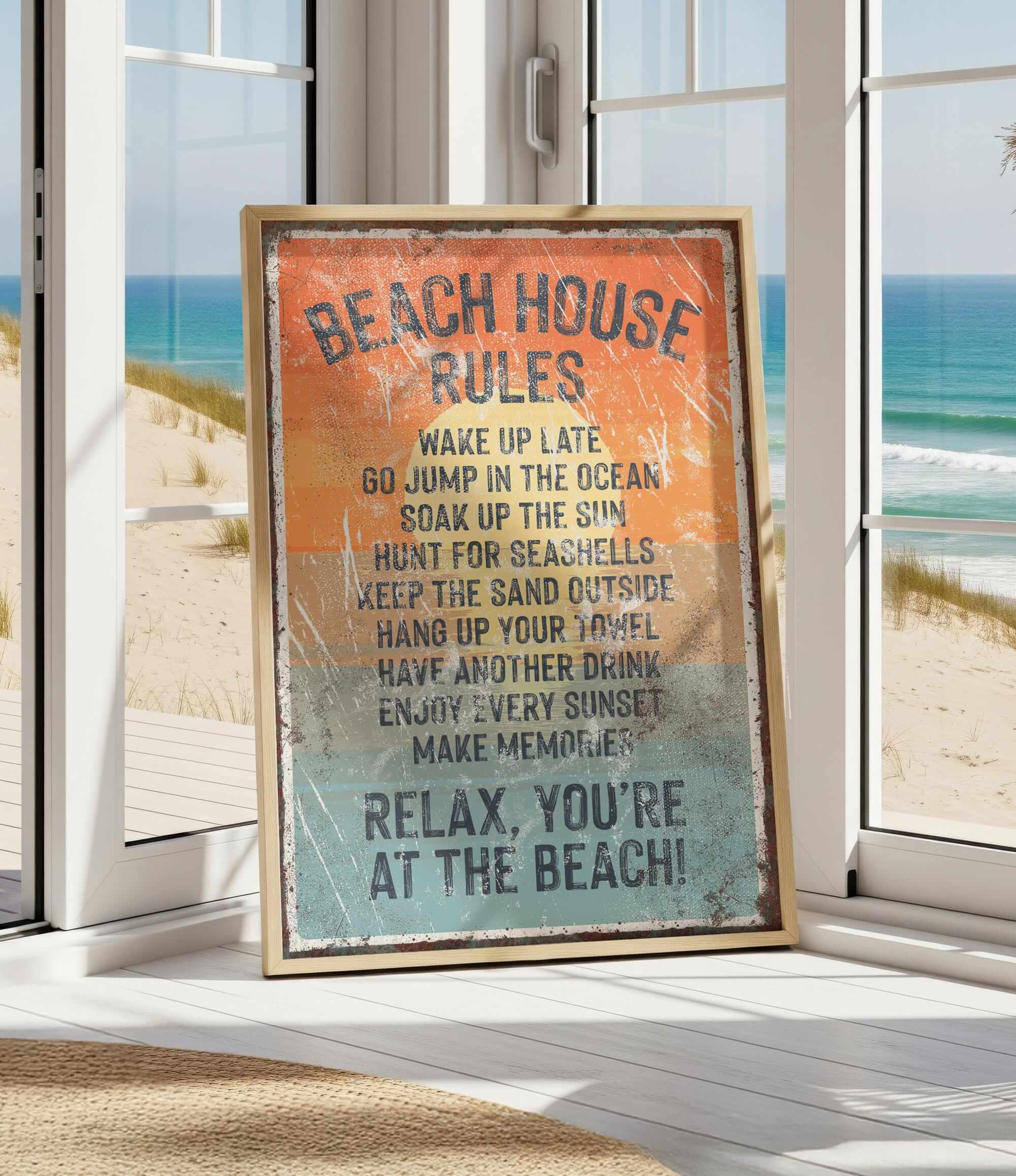 A framed sign with beach rules posted in a beach house, with a view of the ocean through a window.