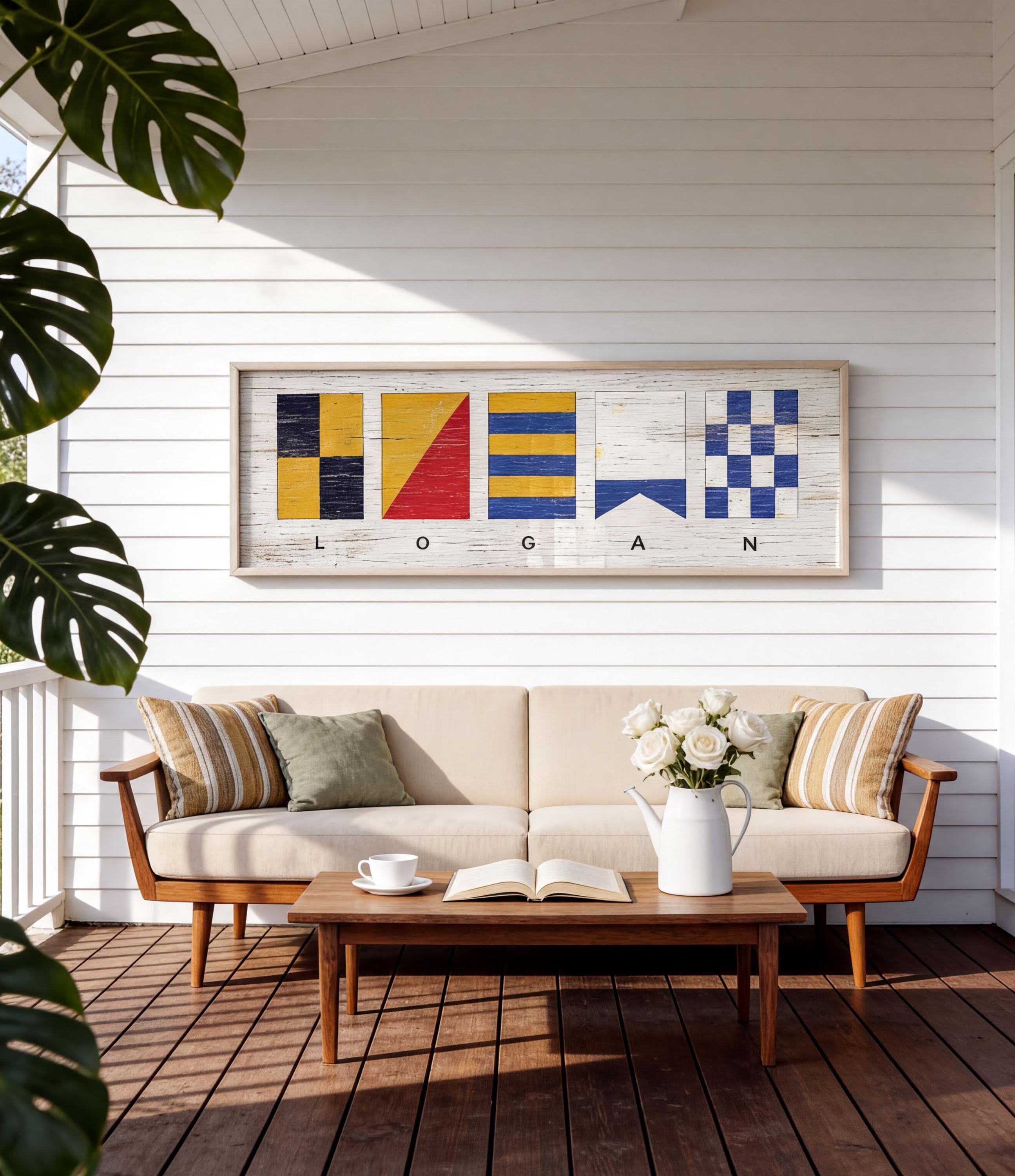 a cozy outdoor seating area with a white sofa, a wooden coffee table, and a framed nautical-themed artwork hanging on the wall above the sofa.