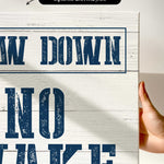 a hand holding a sign that says draw down no wake