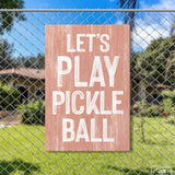 a sign on a fence that says let's play pickle ball