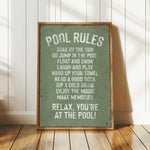 a pool rules sign sitting on top of a wooden floor