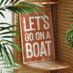 a wooden sign that says let&#39;s go on a boat