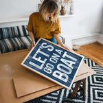 a woman holding a sign that says life is not a box