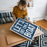a woman holding a sign that says life is not a box