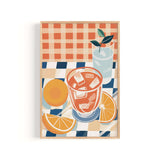 The image is a framed illustration depicting a glass of iced tea with a slice of orange and a lemon, set on a checkered tablecloth.
