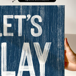 a hand holding a sign that says let&#39;s play