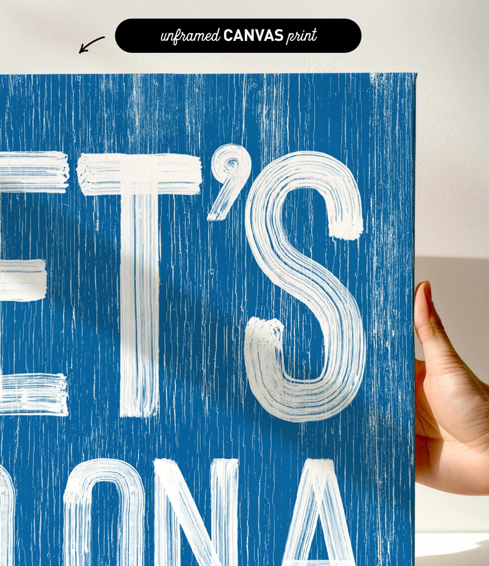 a hand holding a blue sign with white letters