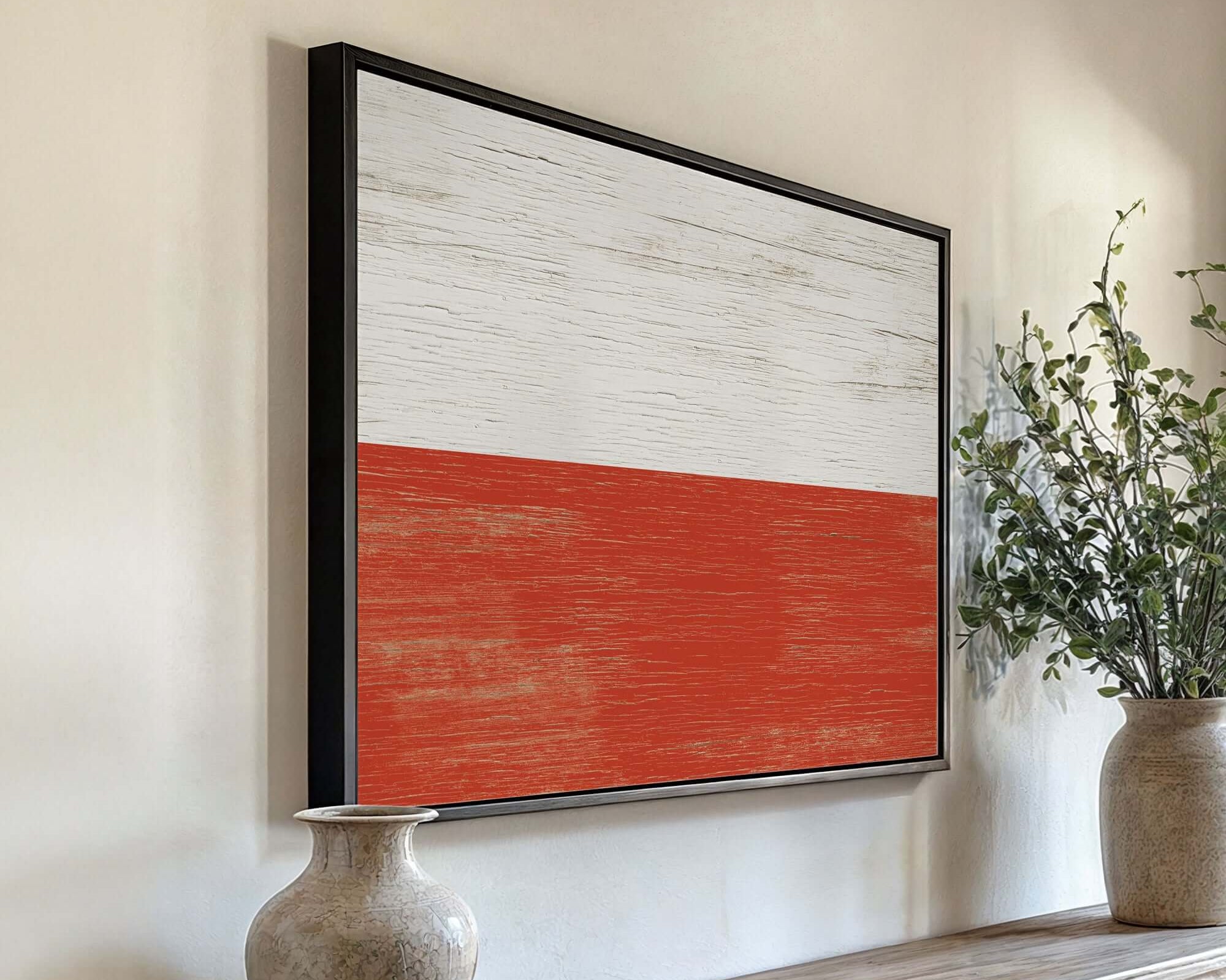 a painting hanging on a wall next to a vase with a plant in it