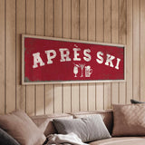 a cozy living room with a large red sign that reads "APRÈS SKI" hanging on the wall above a couch.