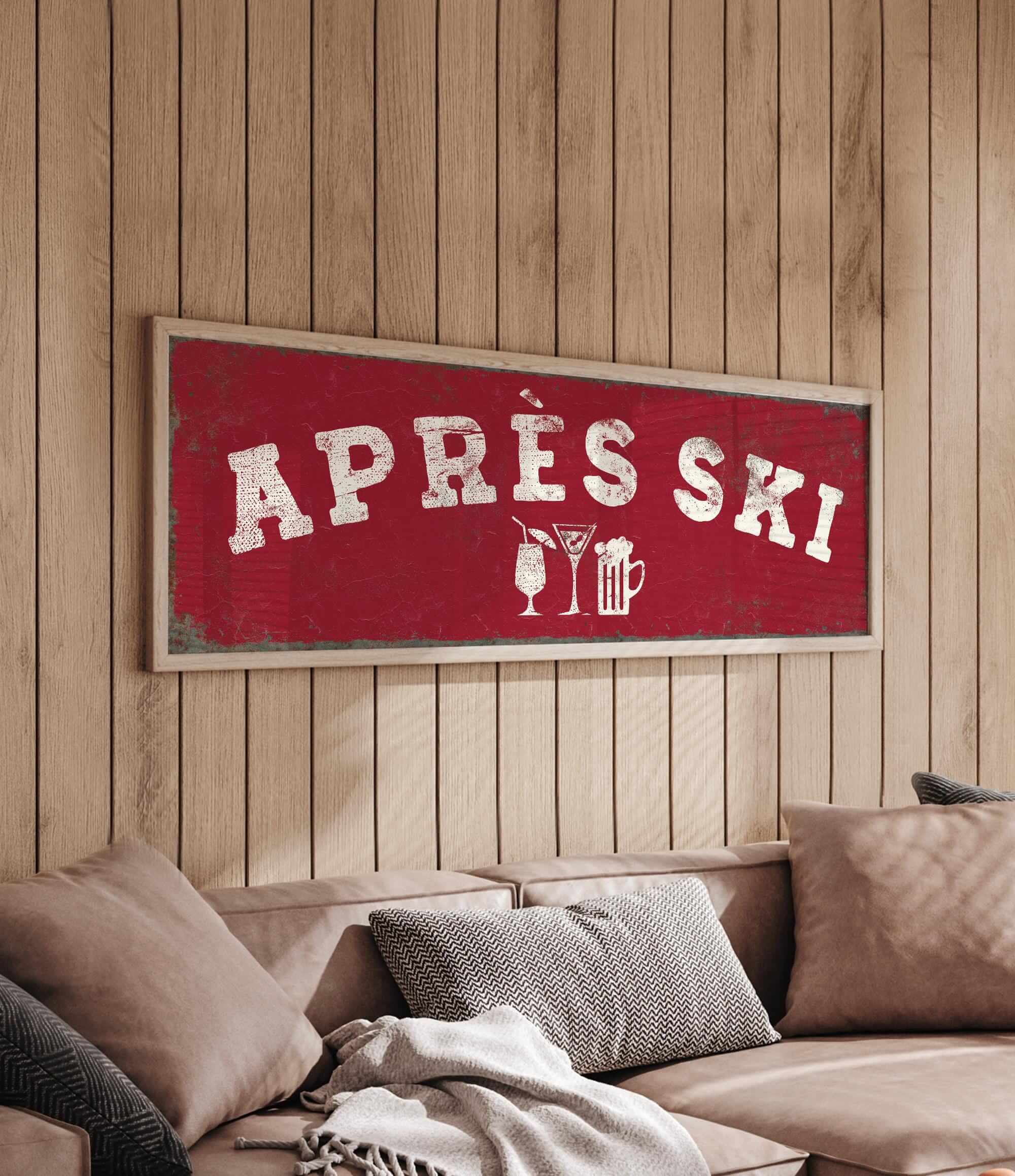 a cozy living room with a large red sign that reads "APRÈS SKI" hanging on the wall above a couch.