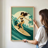 A woman is standing in front of a framed illustration of a woman surfing on a wave, wearing a bikini.