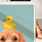 a person holding a framed print of a cartoon image depicting a duck sitting on a dog's head.