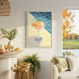 a cozy living room with a white sofa, a bar with stools, and a large window overlooking a scenic outdoor view. The room is decorated with potted plants, a hanging light fixture, and a framed artwork featuring a cocktail glass with fruit.