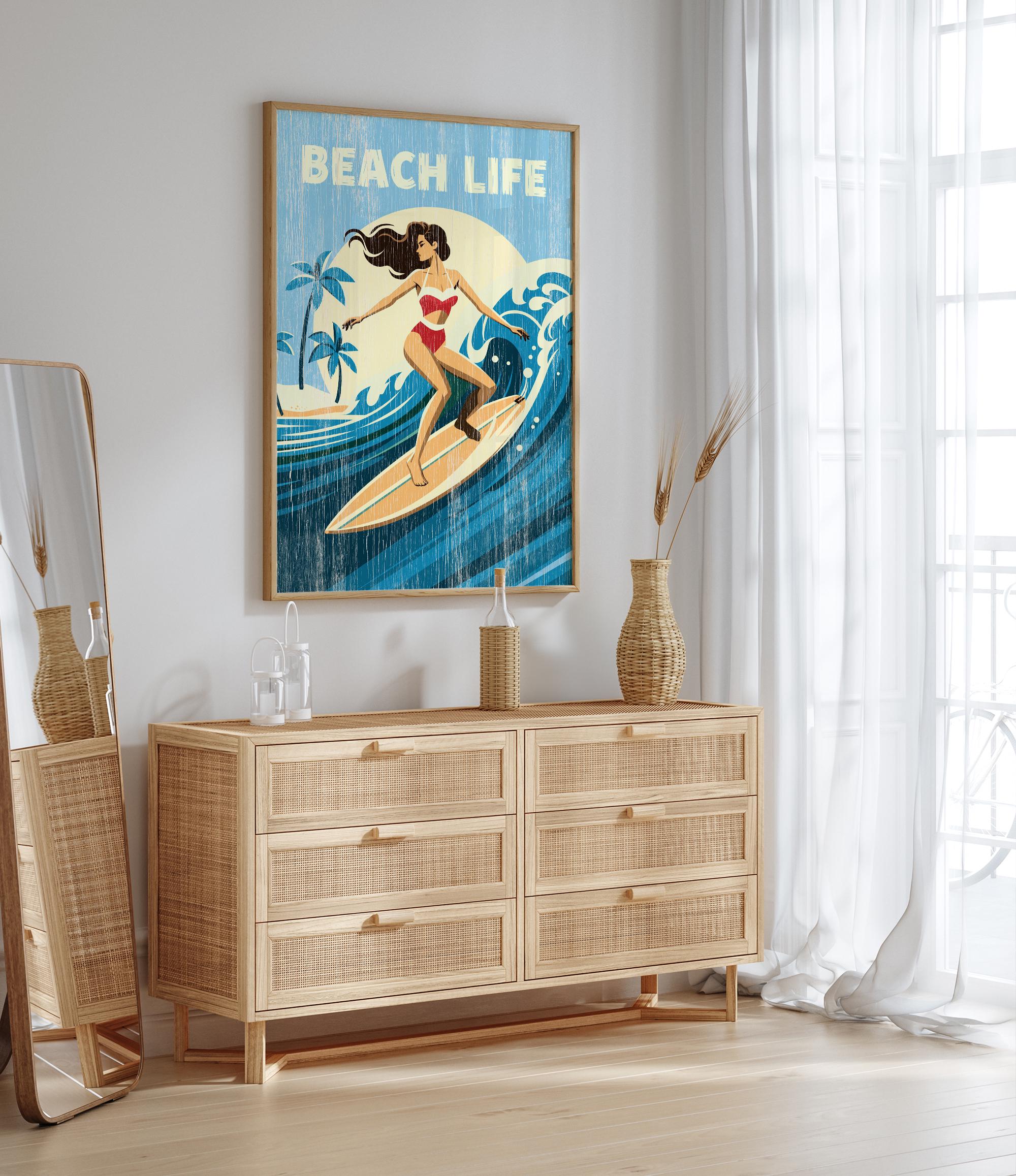 a framed poster of a woman surfing on a wave, with the text "BEACH LIFE" written above it. The poster is displayed on a wall above a wooden dresser with drawers.