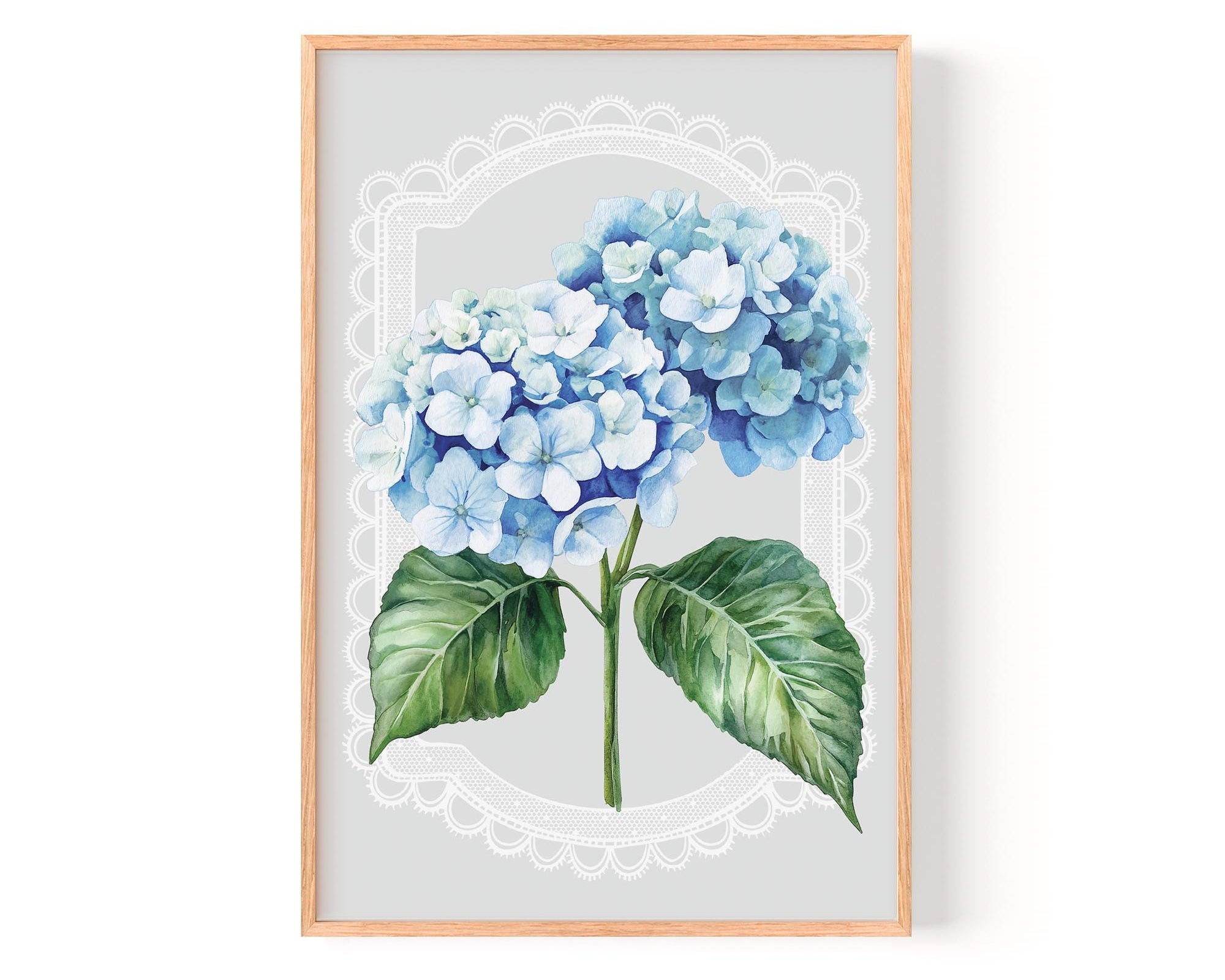 A framed print of a watercolor painting depicting a cluster of blue hydrangea flowers with green leaves.