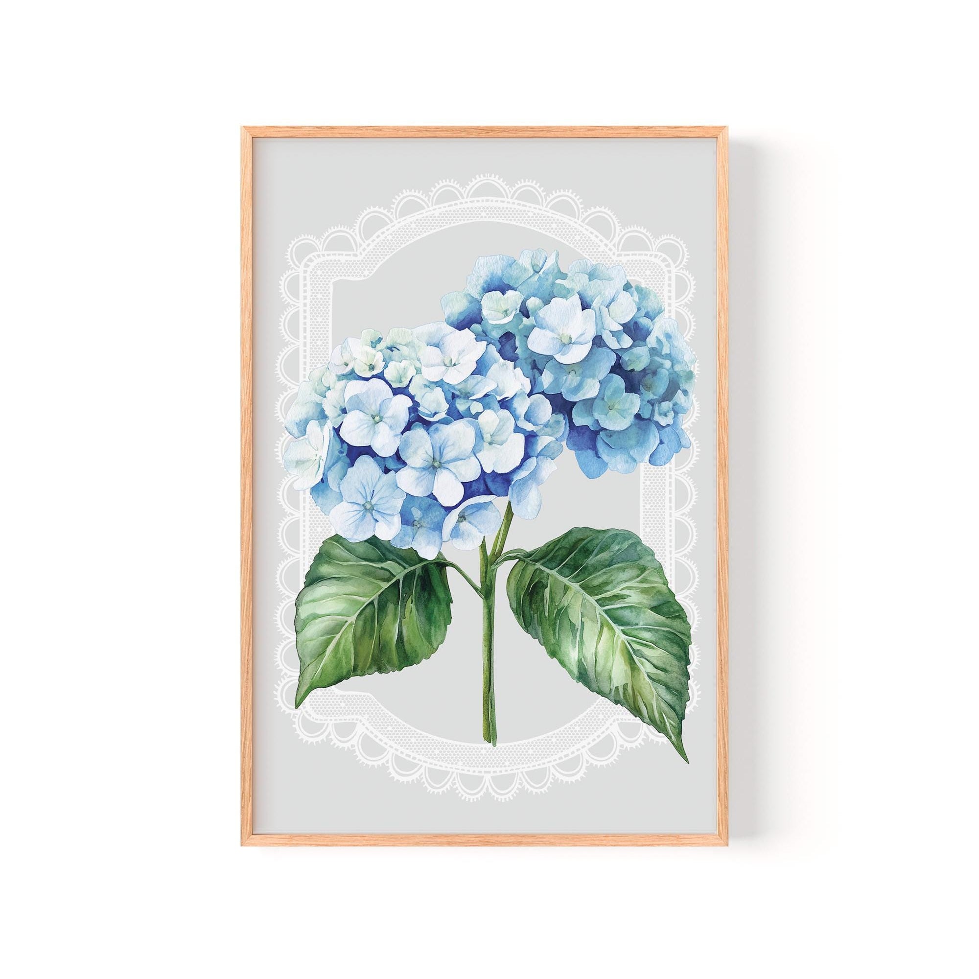 A framed print of a watercolor painting depicting a cluster of blue hydrangea flowers with green leaves.