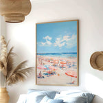 a beach scene with people enjoying the sun and sand, featuring colorful umbrellas and a clear blue sky.