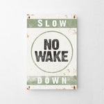 a sign that says slow no wake down