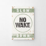 a sign that says slow no wake down