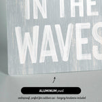 a wooden sign that says in the waves