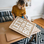 a woman holding a cardboard sign that says let&#39;s do what you want