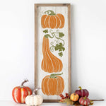 a picture of pumpkins and gourds on a shelf