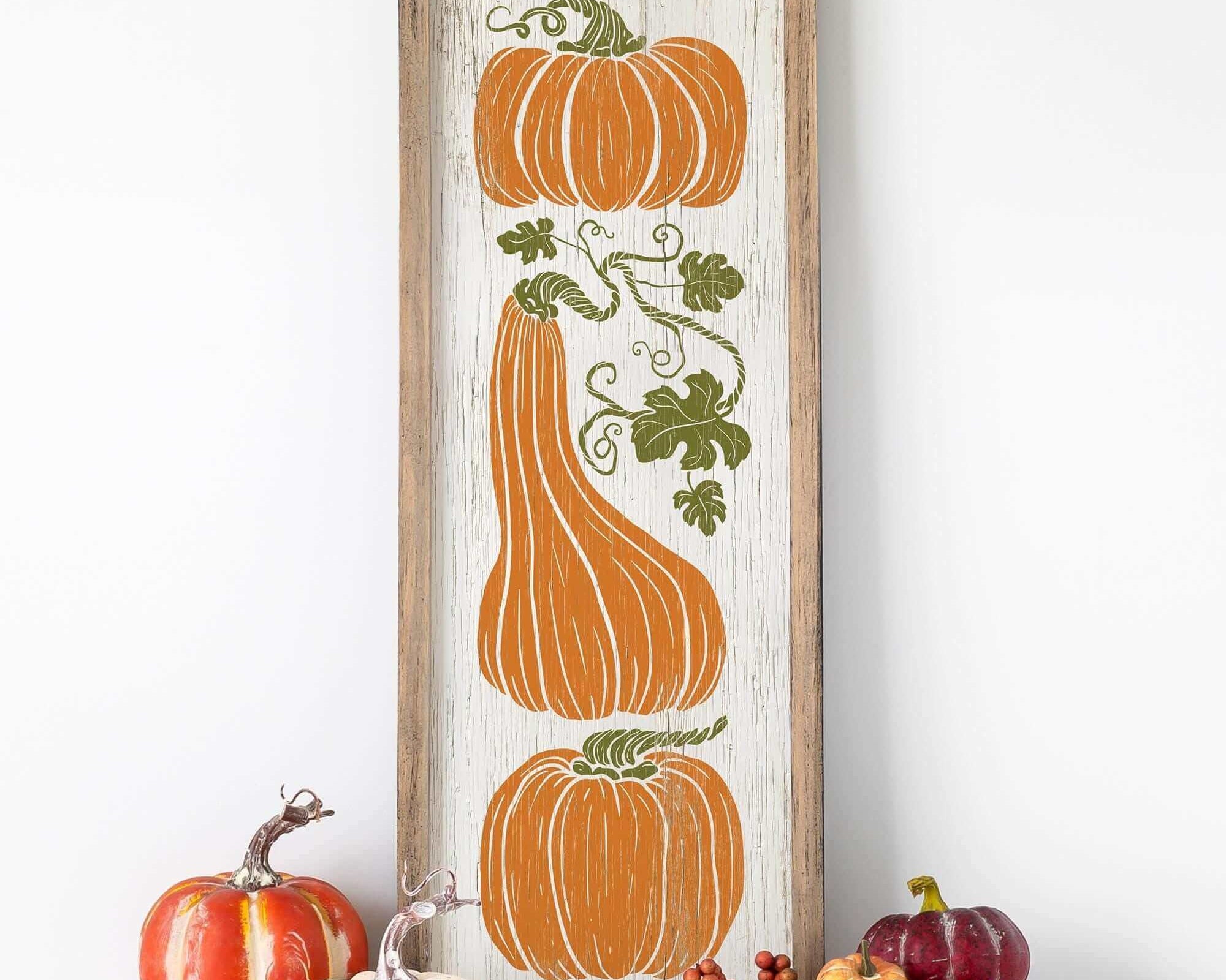 a picture of pumpkins and gourds on a shelf