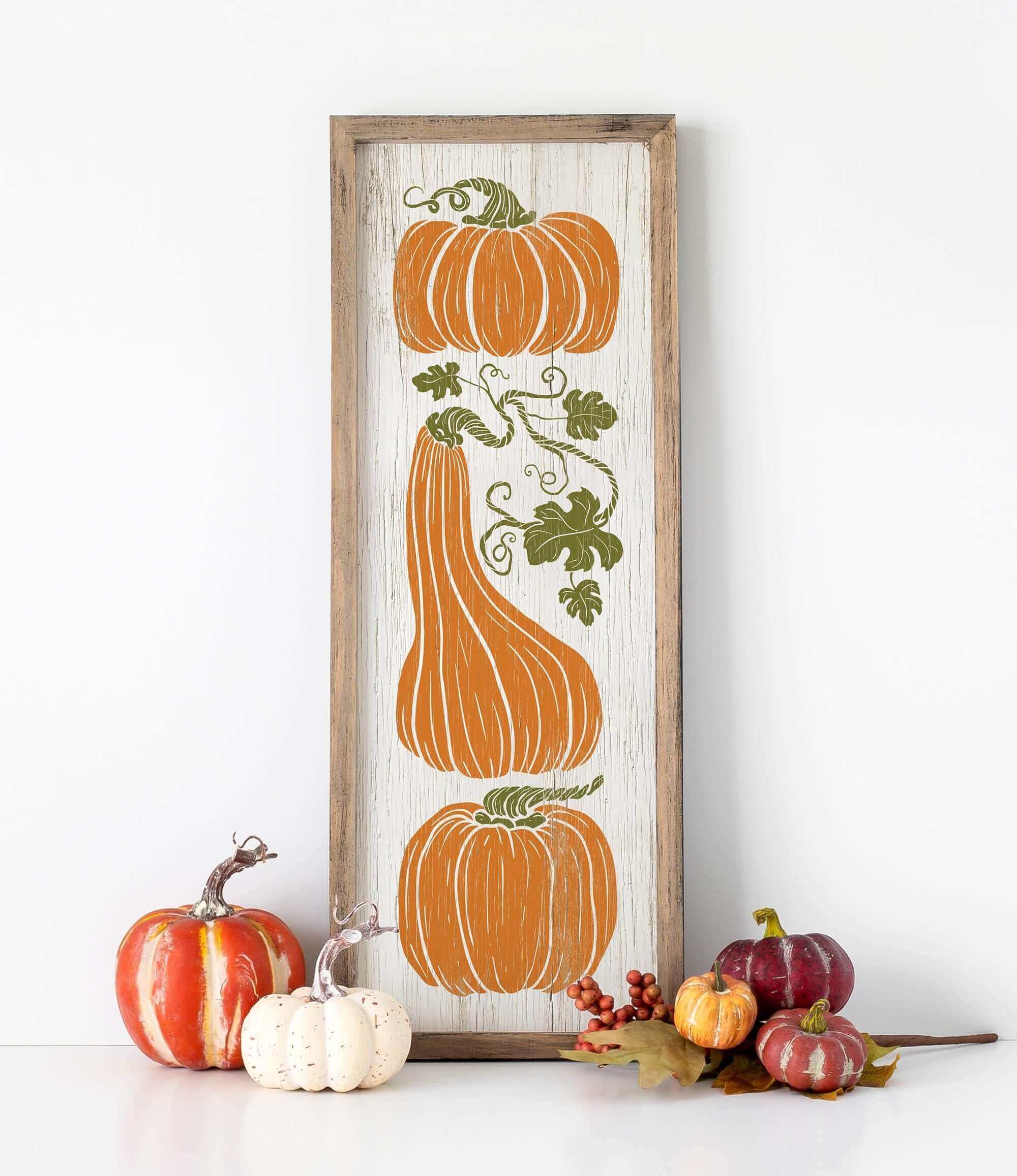 a picture of pumpkins and gourds on a shelf