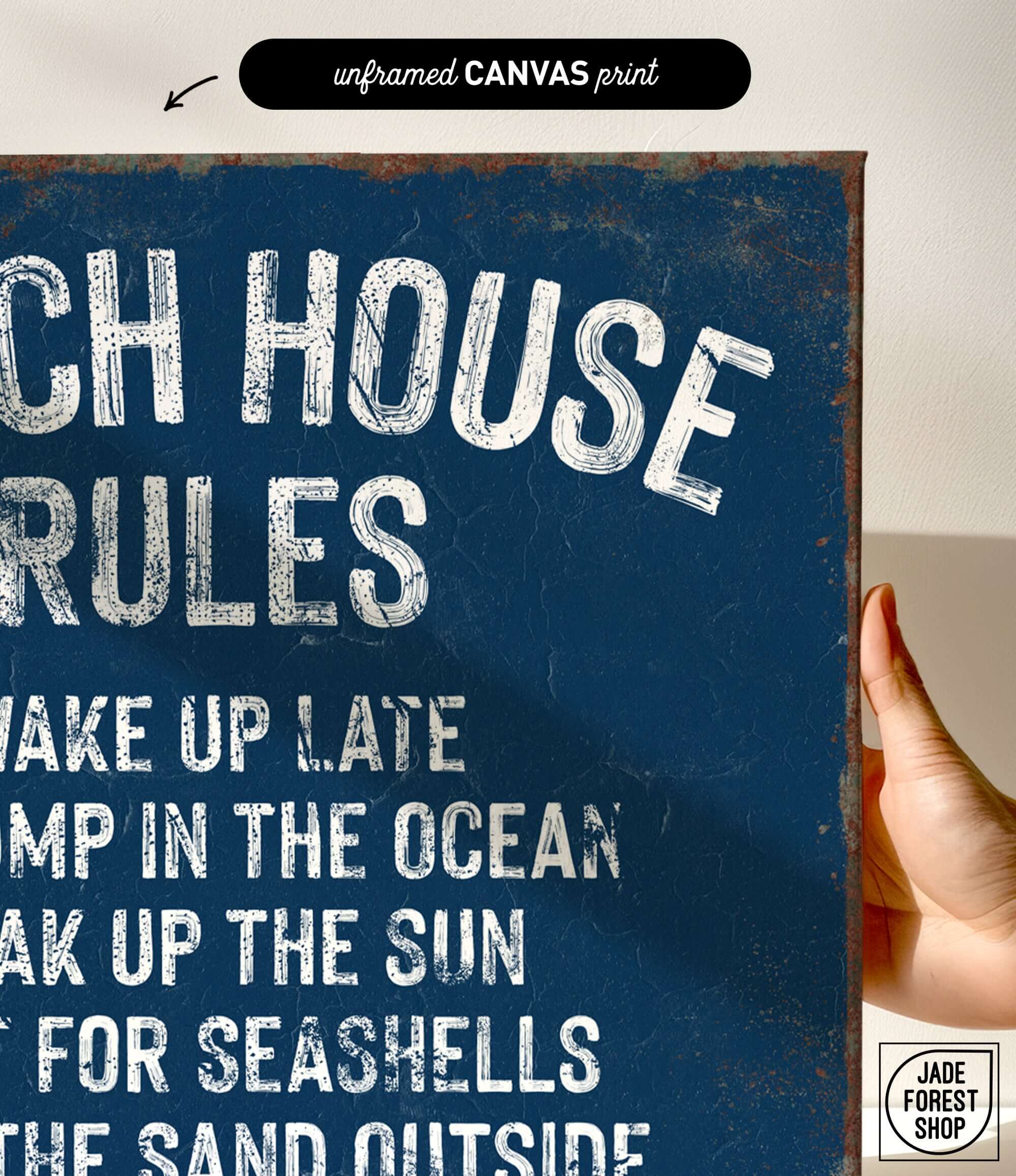 a hand holding a sign that says beach house rules