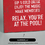 a picture of a red sign that says relax you&#39;re at the pool