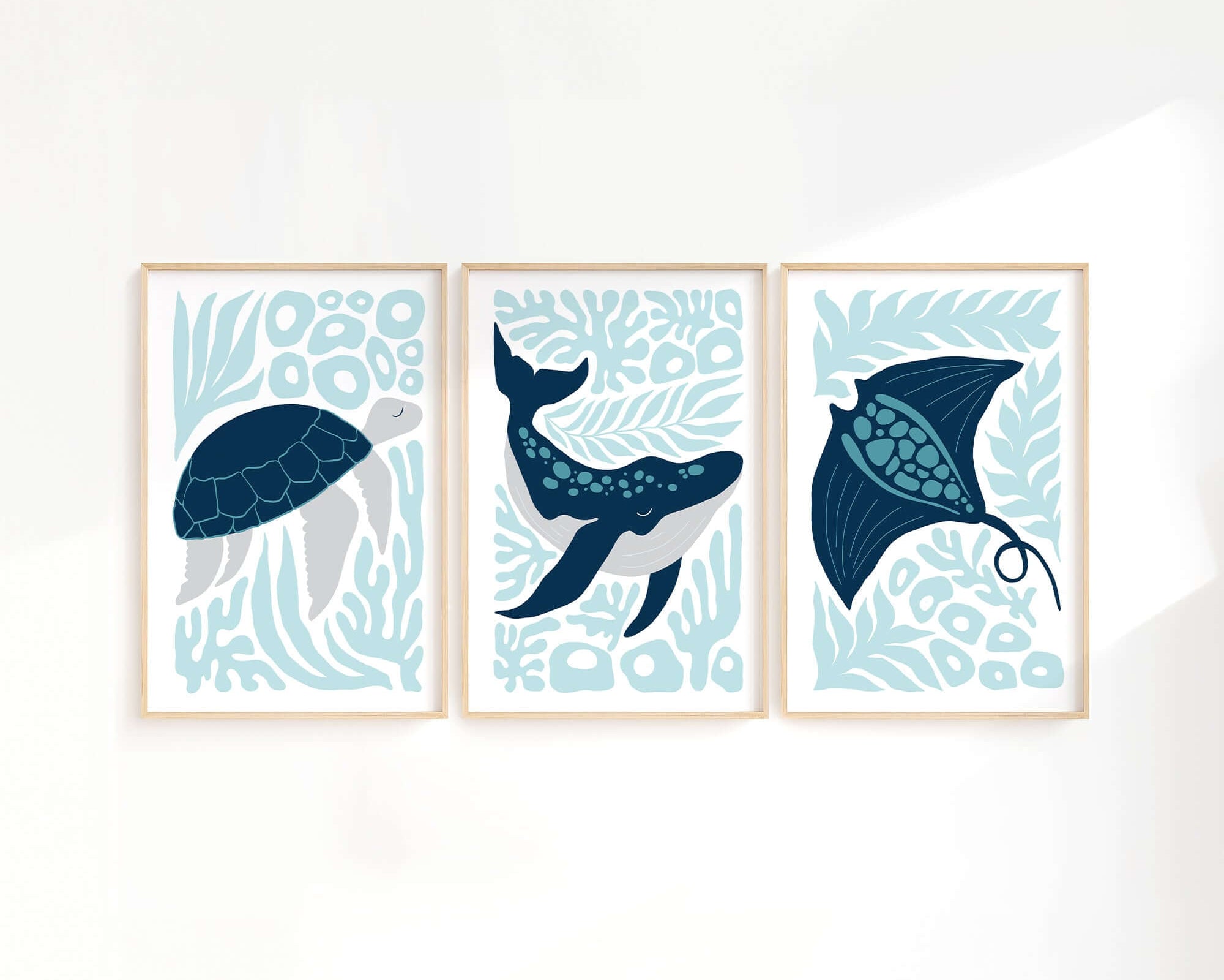 The Ocean Blocks Triptych | Set of Three Prints | 334 features framed art with a sea turtle, whale, and stingray on abstract blue backgrounds—perfect for adding unique decor to any white wall.