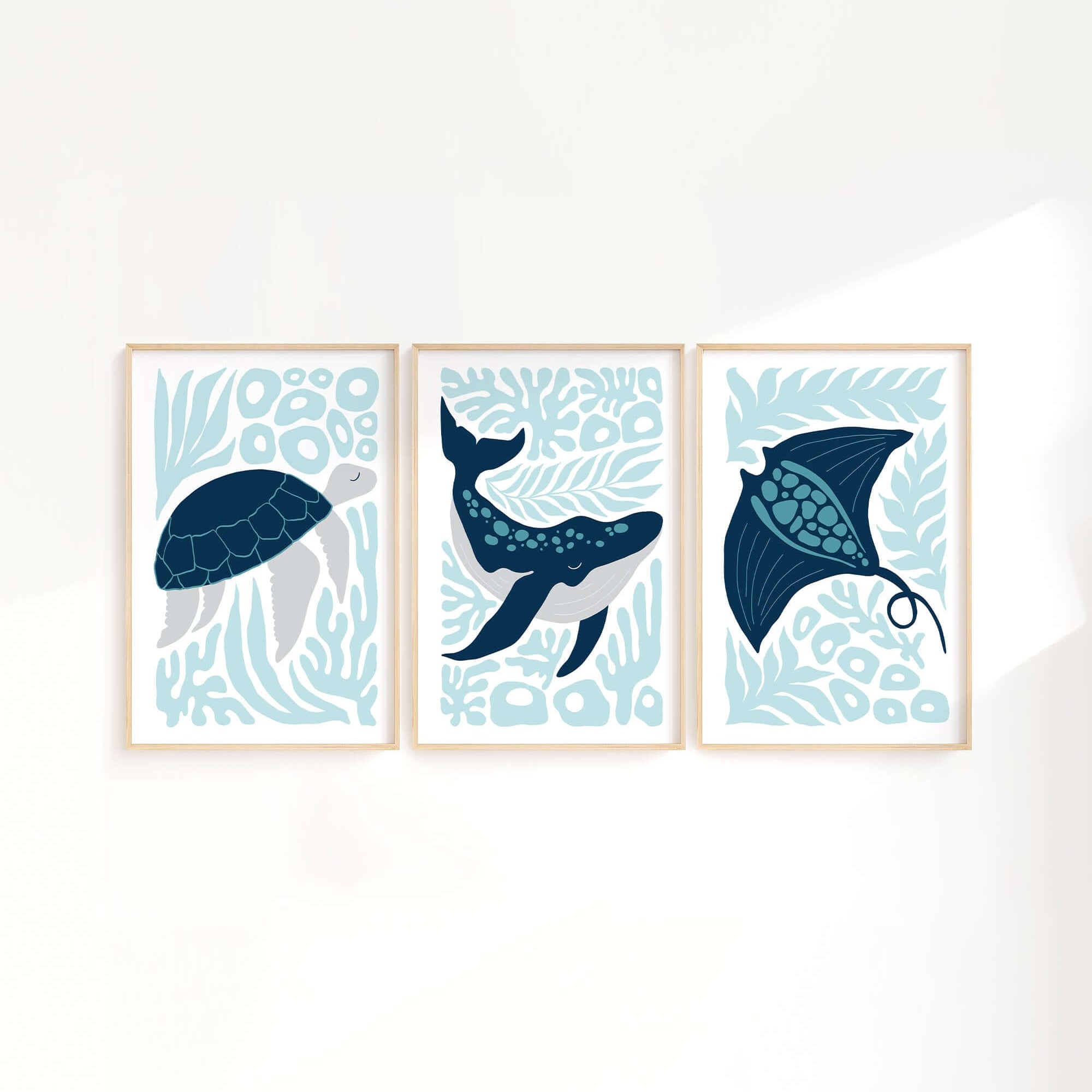 The Ocean Blocks Triptych | Set of Three Prints | 334 features framed art with a sea turtle, whale, and stingray on abstract blue backgrounds—perfect for adding unique decor to any white wall.