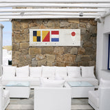 a living room with white furniture and a stone wall