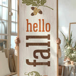 a person holding up a sign with a picture of a pumpkin