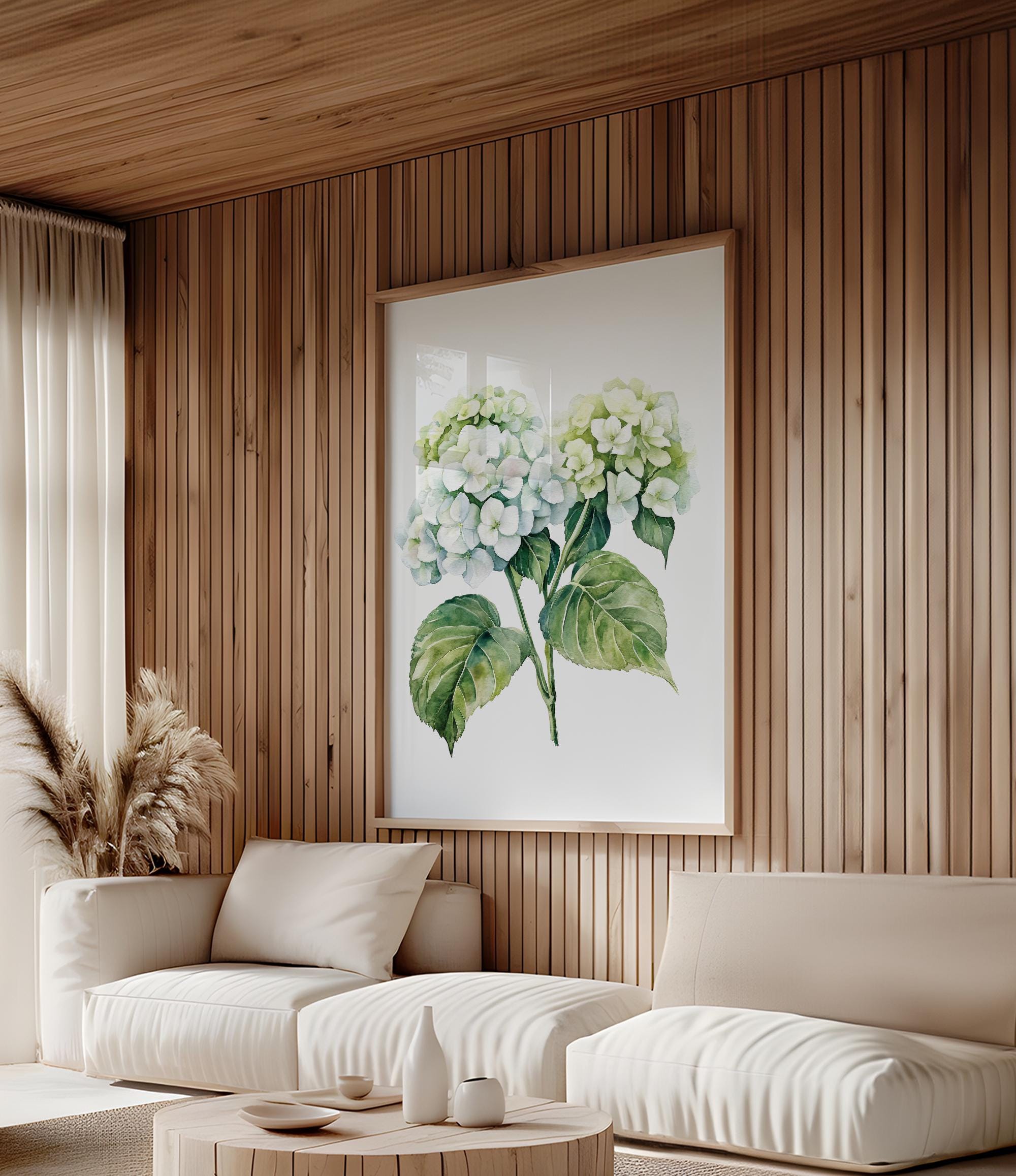 a cozy living room with a large framed print of a green hydrangea flower hanging on the wall. The room features a white sofa, a coffee table, and a potted plant, creating a warm and inviting atmosphere.